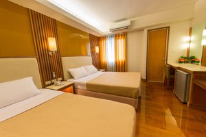 Kabayan Hotel in Luzon, image may contain: Flooring, Bed, Chair, Lighting