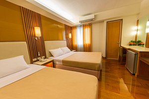 Kabayan Hotel in Luzon, image may contain: Flooring, Bed, Chair, Lighting