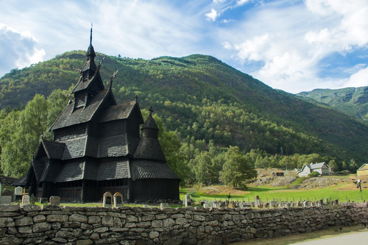 Impressive facade of Borgund Stave Church displaying its intricate wooden carvings and distinct dragon heads