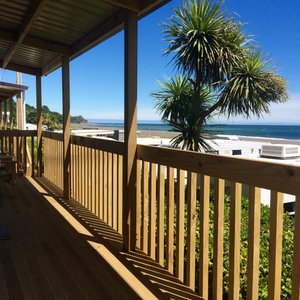 🌴 Relax on Your Private Deck 🌴

Enjoy the stunning ocean views from the private deck of Unit 14 at Oakura Beach Holiday Park. With lush palm trees and the sparkling sea as your backdrop, this spacious outdoor area is perfect for soaking up the sun and unwinding. Ideal for a morning coffee or an evening drink, the serene setting offers a slice of coastal paradise right from your doorstep. Experience relaxation and natural beauty in one perfect package.