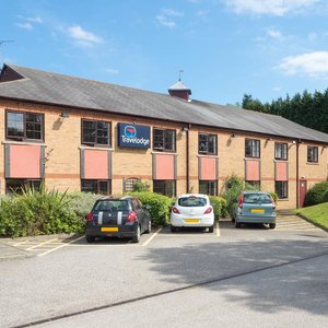 Travelodge Newcastle Airport in Newcastle upon Tyne, image may contain: Car, Vehicle, Housing, House