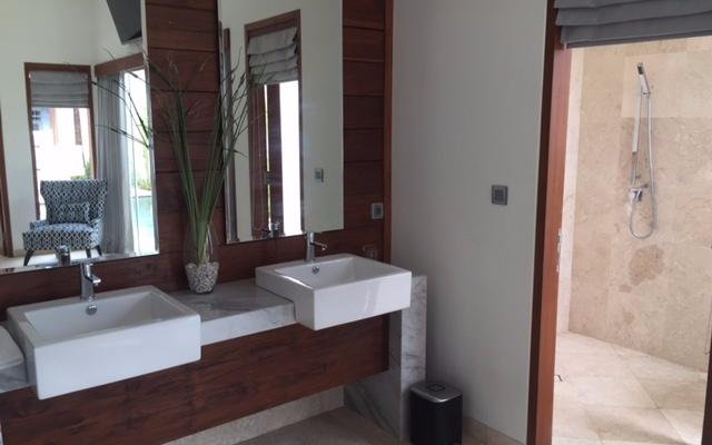 Marble Bathroom with Dual Vanities leading to outdoor shower