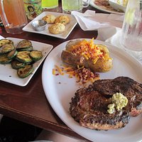 Cajun ribeye with loaded potatoe and grilled zucchini