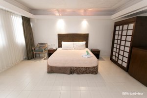 Wild Orchid Beach Resort in Luzon, image may contain: Chair, Furniture, Bed, Bedroom