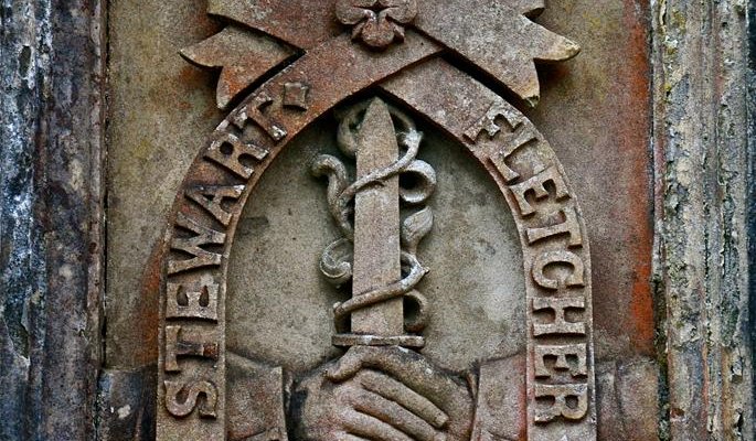 An heraldic device set in the curtain wall