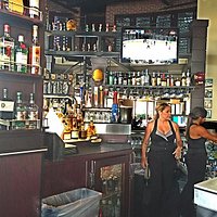 The bar is very large and well-equipped with staff, beverages and TVs
