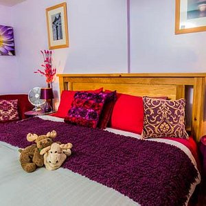 The super kingsized bed in the Cerise Suite