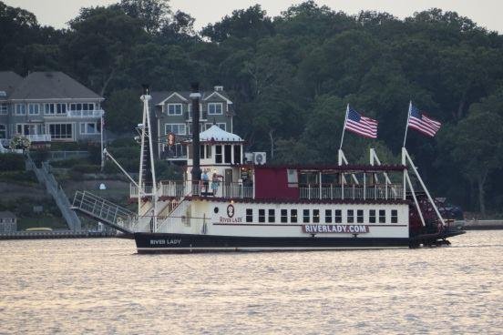 There are beautiful Victorian houses along the river.