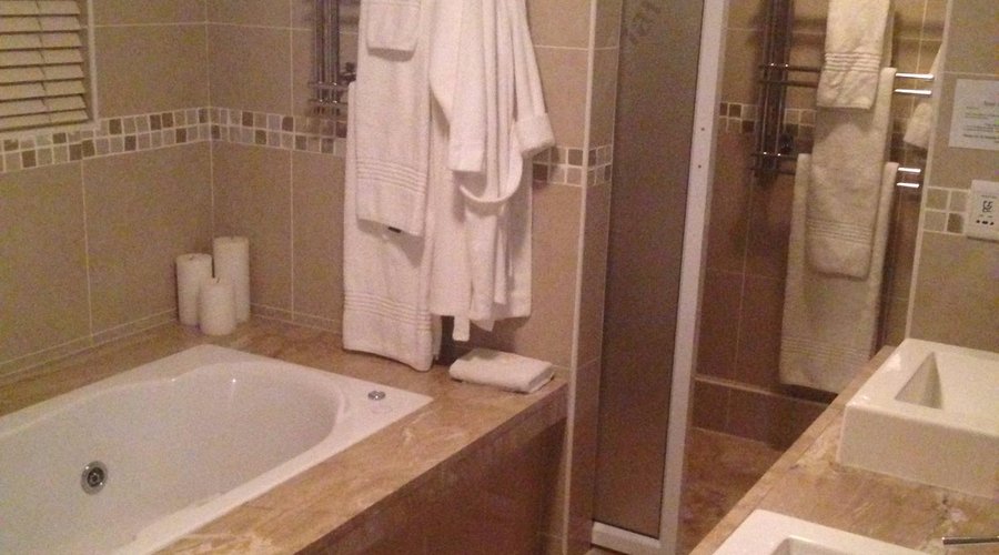honeymoon suite in room spa bath leading to shower room and toilet