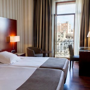 Hotel Zenit Valencia in Valencia, image may contain: Furniture, Bedroom, Bed, Indoors