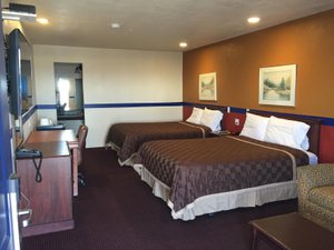 Country Manor Motel in Watkins, image may contain: Bed, Furniture, Bedroom, Handbag