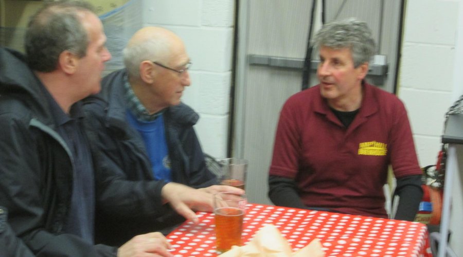 Peter chatting with two visitors