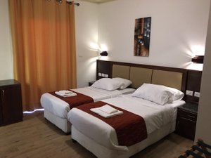 Shepherd Plaza Hotel in Bethlehem, image may contain: Furniture, Bed, Bedroom, Home Decor
