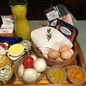 Our breakfast basket with bacon, sausages, mushrooms, tomato, bread, butter, condiments and more