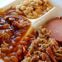 Two-side dinner plate: Pulled pork, white beans, "hillbilly beans", and a slice of smoked bologn