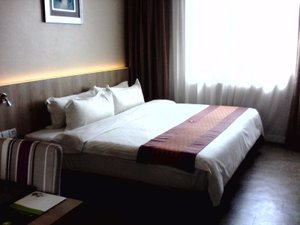 56 Hotel in Kuching, image may contain: Furniture, Bed, Bedroom, Chair