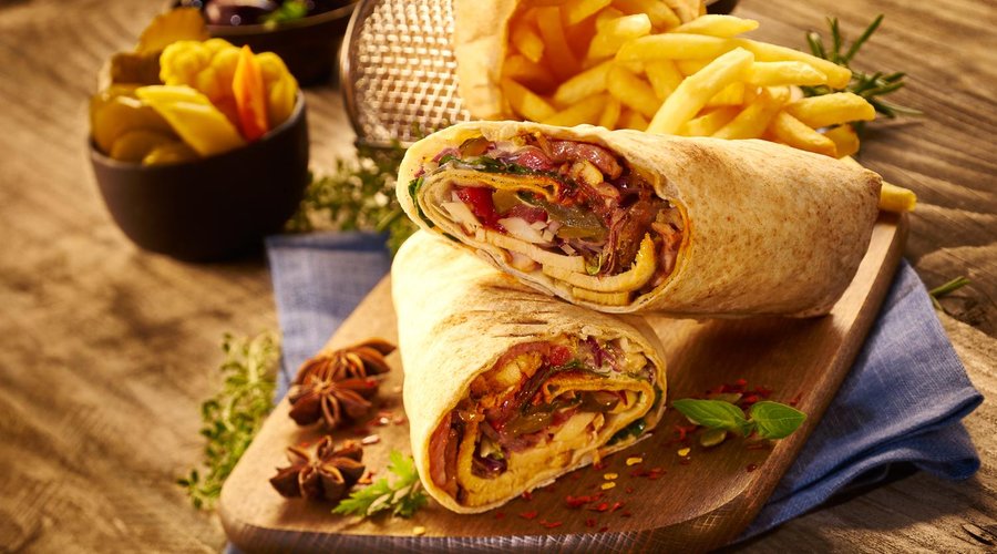 Chicken shawarma with parsley, garlic sauce, tomatoes, home made pickles, red onion, sumac, hari