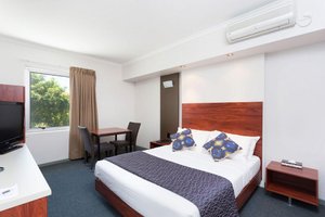 Rocklea International Motel in Brisbane, image may contain: Monitor, Screen, Bed, Chair