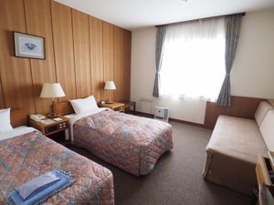Hotel Tateyama in Tateyama-machi, image may contain: Bed, Furniture, Couch, Lamp