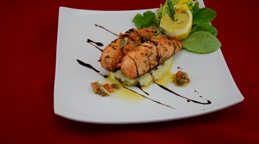 salmon served in creamy white wine, lemon sauce served n a bed of mash potato