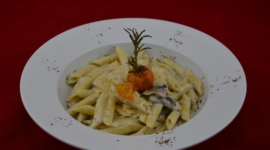 penne- pasta cooked in thick creamy sauce