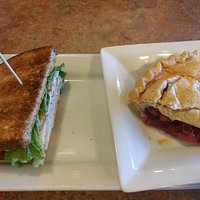 Half turkey sandwich with cherry pie