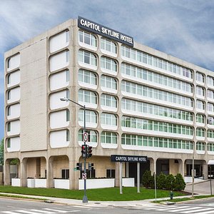 Capitol Skyline Hotel in Washington DC, image may contain: Lamp, Furniture, Home Decor, Bed