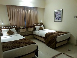 Seasons - An Apartment Hotel in Pune, image may contain: Bed, Furniture, Bedroom, Painting