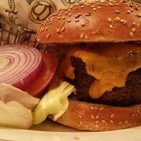 Charbroiled outside, rare inside. Thick slab smoked bacon and sharp cheddar. A perfect burger!