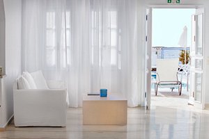Poseidon Beach Hotel in Santorini, image may contain: Floor, Flooring, Living Room, Interior Design