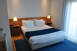 OPO Hotel Porto Aeroporto in Maia, image may contain: Furniture, Bed, Bedroom, Lamp