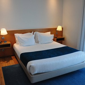 OPO Hotel Porto Aeroporto in Maia, image may contain: Furniture, Bed, Bedroom, Lamp