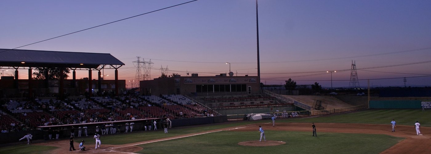 The sun sets behind the stadium