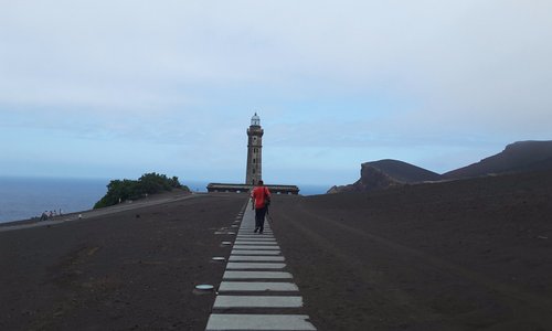 Walkway to the underground information centre with lighthouse in the background 