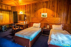 Olathang Hotel in Paro, image may contain: Interior Design, Wood, Bed, Stained Wood