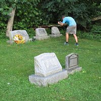 My son taking photos of tombstones