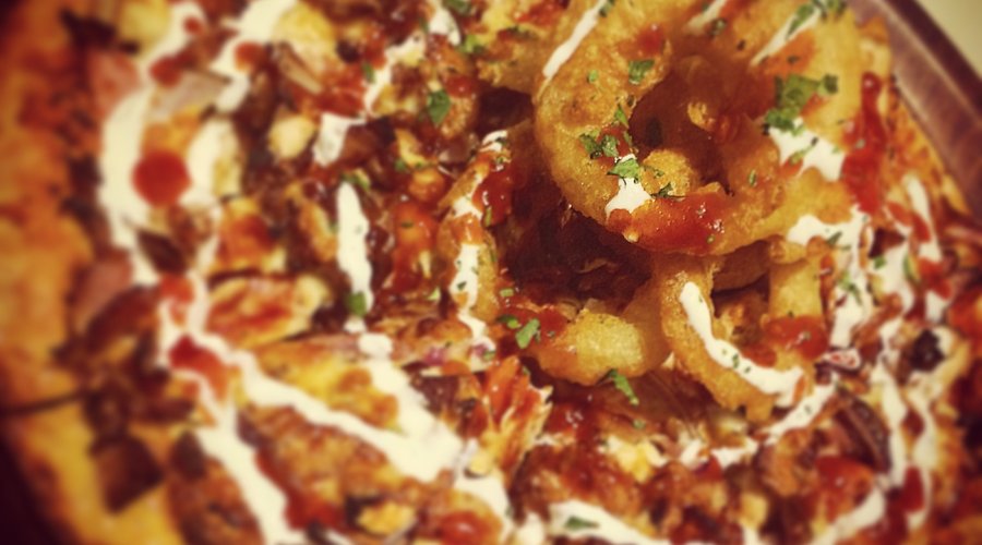Americano special w house made smoky BBQ sauce, ranch dressing and crispy battered onion rings