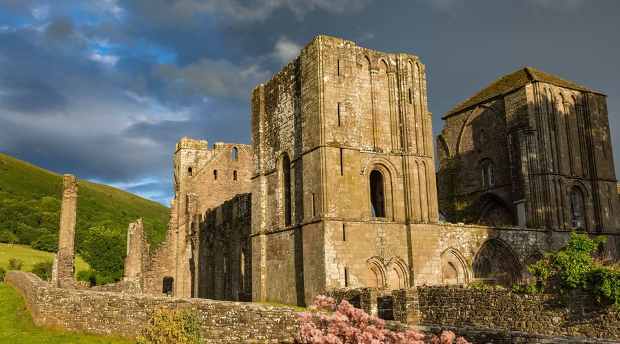 The low evening sun illuminates the priory