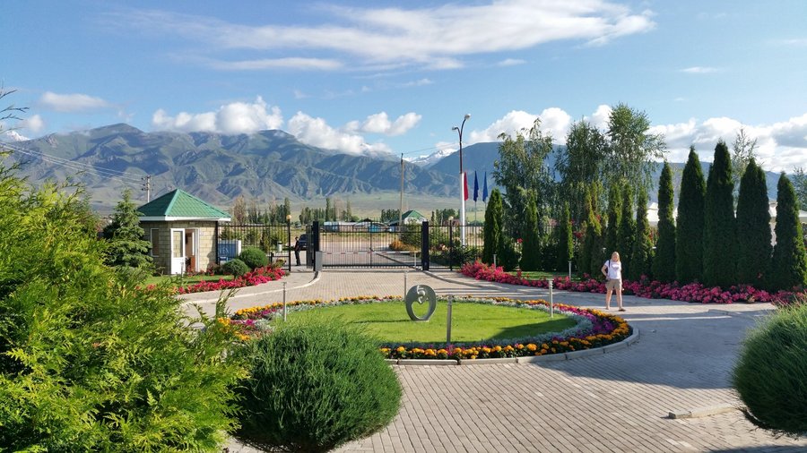 Hotel entrance with manicured gardens and mountain views