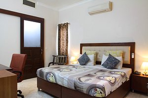 Perch Arbor Suites in Gurugram (Gurgaon), image may contain: Furniture, Chair, Bedroom, Dorm Room