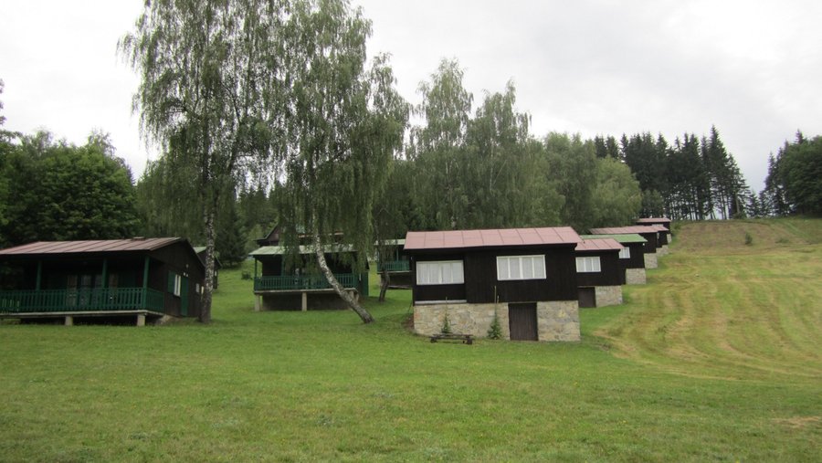 Pic from the bottom of the hill - huts on right have no veranda