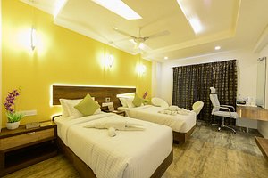Hotel Chenthur Park in Coimbatore, image may contain: Bed, Furniture, Ceiling Fan, Bedroom