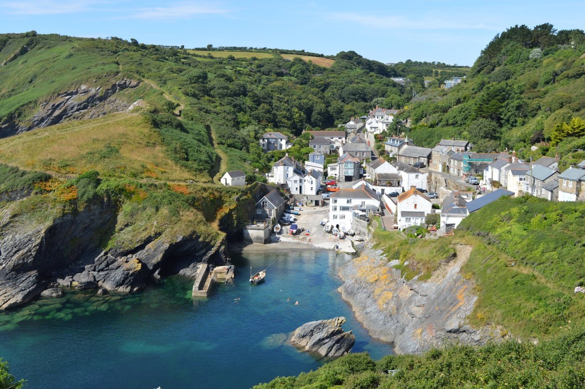 Stunning architecture of Portloe village featuring traditional stone cottages nestled around a small, picturesque harbour and steep hillsides