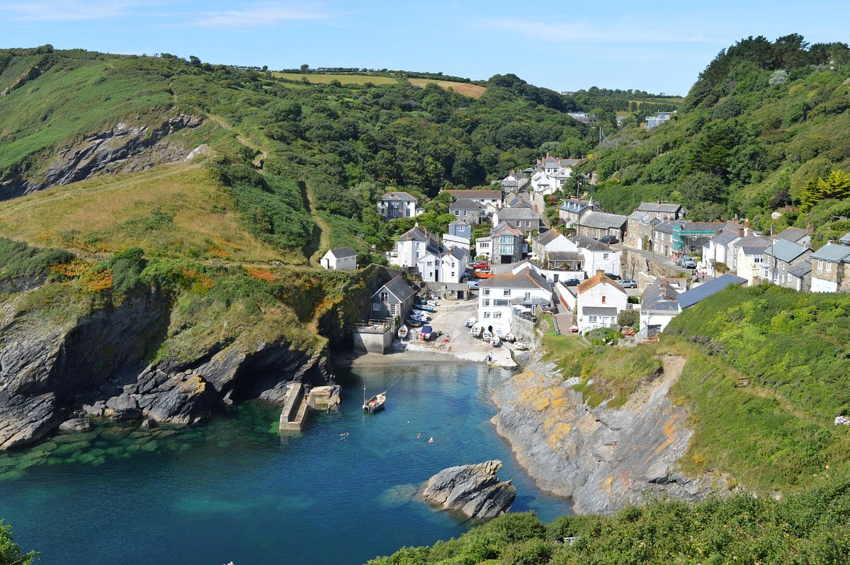 Stunning architecture of Portloe village featuring traditional stone cottages nestled around a small, picturesque harbour and steep hillsides
