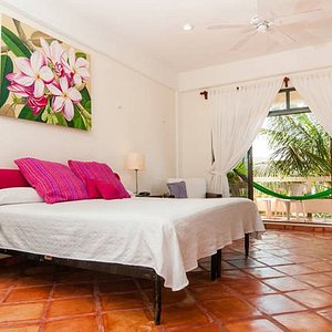 Spacious upper level room with a king size bed and breezy balcony with a hammock, 
