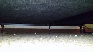 Photo under the bed in a room. In some rooms you can not see under the bed because of awoodstruc