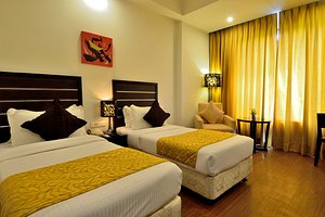 Lakshya's Hotel in Haridwar, image may contain: Bed, Furniture, Bedroom, Hotel