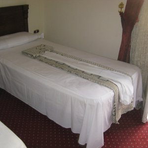 The decorations on the bed is actually your bedding and you have to make your own bed.