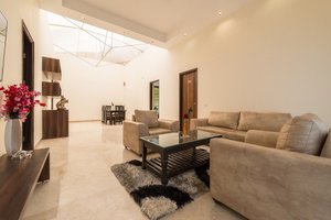 CGH Guest House in Bengaluru, image may contain: Living Room, Home Decor, Coffee Table, Table