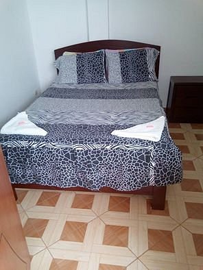 Hospedaje Oceano in Huanchaco, image may contain: Furniture, Bed, Crib, Bed Sheet